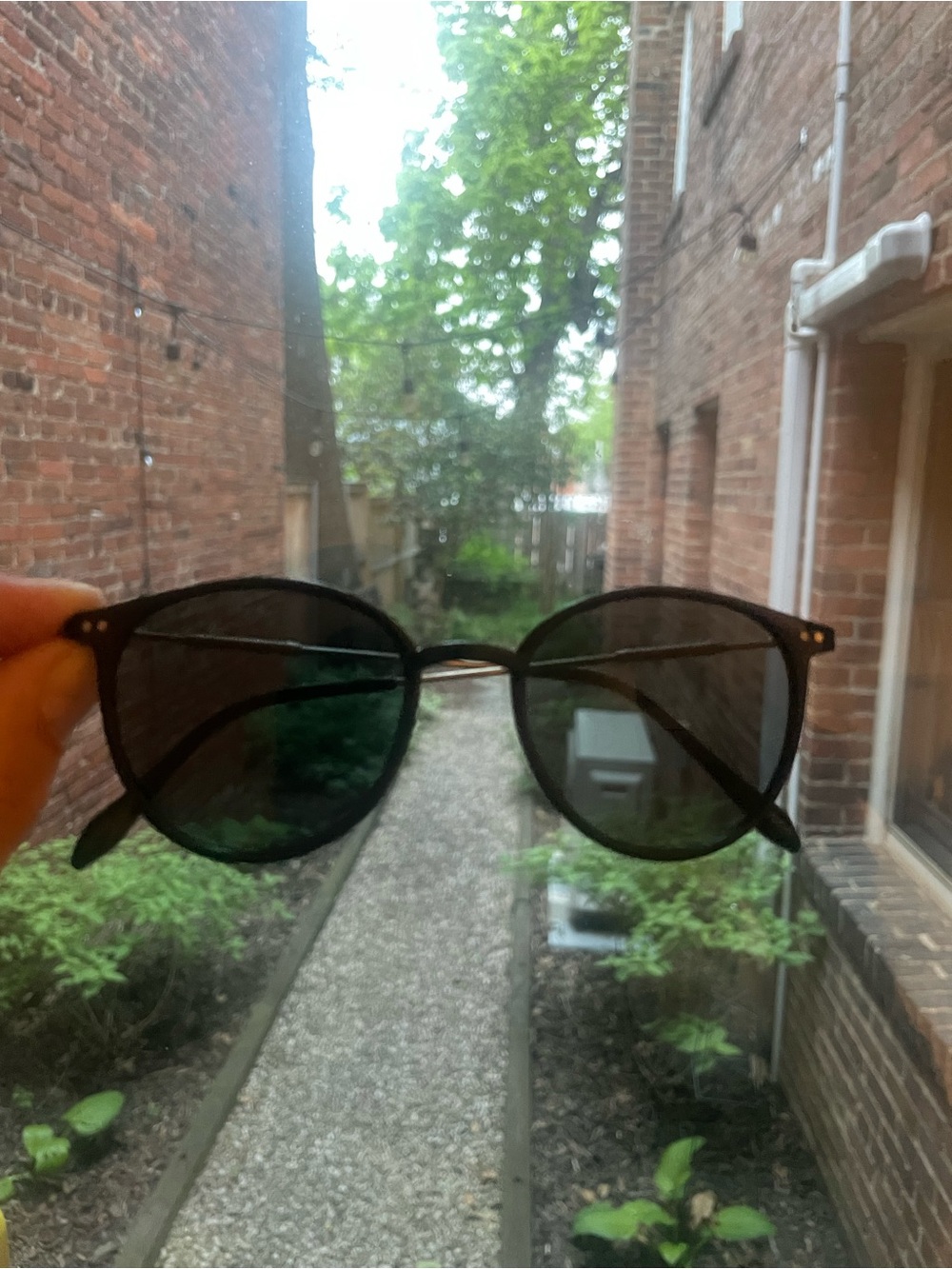 round sunglasses with black frame & dark lenses